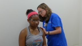 Dr. Gayle Beyl of North Oaks Primary Care in Livingston performs a heart and lung check on Amira Raddler, 12. Raddler is a point guard for Doyle Junior High School’s Lady Tigers.